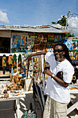 Jamaica Negril beach cool Rastafari man with souvenir shop