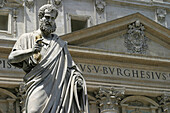 Statue of Saint Peter, and St. Peters Basilica facade. Vatican City. Rome. Italy