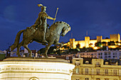 Dom João I statue in Praça da Figueira and St. Georges Castle at night, Lisbon. Portugal
