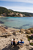 Couple Relaxing on Sant Elm Beach, Sant Elm, Mallorca, Balearic Islands, Spain