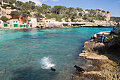 Family with Dogs at Cala Llombards Cove, Cala Llombards, Mallorca, Balearic Islands, Spain