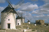Windmills with castle at backgroung in Consuegra. Toledo province. Castilla-La Mancha. Spain