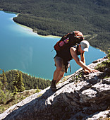 Hiker below Sunset Pass with Pinto lake in the background. Banff National Park. Alberta. Canada