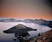 Moon over Crater Lake and Wizard Island at twilight. Crater Lake National Park. Oregon. USA.