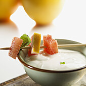 Bowl of yoghurt with grapefruit and mint brochette