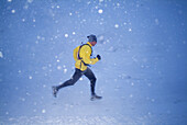 Man running in the snow in winter on Donner Summit, California. USA