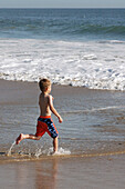 Seven years old child. Crystal Cove State Park. California. USA.