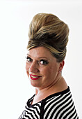 Glamourous woman with 1950s style beehive hairstyle.