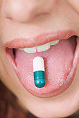 Action, Capsule, Capsules, Close up, Close-up, Closeup, Color, Colour, Detail, Details, Drug, Drugs, Female, Health, Human, Medical, Medicine, Medicines, Mouth, Mouths, One, One person, Open mouth, People, Person, Persons, Pill, Pills, Show, Showing, Sing