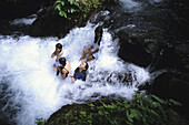 Girls sitting in waterfall in Iligan City, Mindinao, Philippines.