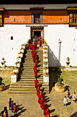 Procession of monks leaving the Paro Dzong going to the Paro Tsechu (Festival), Paro, Bhutan
