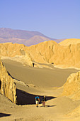 Sandboarders walking in Death Valley (Valle de la Muerte), Salt Mountain Range, Atacama Desert, Chile
