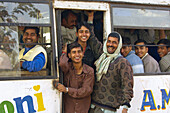 A bus load of people riding down the road between Fatehpur Sikri and Agra, Uttar Pradesh, India