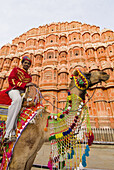 Man on camel in front of the Hawa Mahal (Palace of the Winds), Jaipur, Rajasthan, India