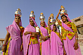 Group of women walk through the Sachiya Mata Temple during a Hindu haircutting ceremony (boys first haircut, a rite of purification), Osian, Rajasthan, India