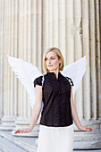 Angel, young woman with wings standing next to columns, Königsplatz, Munich, Bavaria, Germany