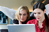 Two women using a laptop