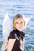 Angel, young woman with wings at Lake Starnberg, Bavaria, Germany
