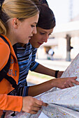 Two young women reading a map