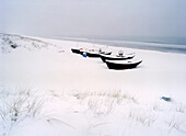 Snow covered boats at beach, Baabe, Rugen island, Mecklenburg-Western Pomerania, Germany