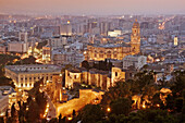 Overview at dusk on Málaga: Customs House, cathedral and Alcazaba. Costa del Sol, Andalusia. Spain