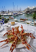 Lobsters dish in restaurant by marina, Benalmádena. Costa del Sol, Málaga province. Andalusia, Spain