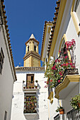Typical street and parish church of La Virgen de los Remedios. Estepona. Málaga province, Costa del Sol. Andalusia, Spain