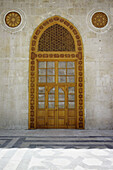 Detail of door to the prayer hall of the Umayyads Mosque showing the ornate wooden latticework above. Halab, Syria