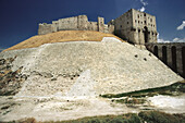 Great Citadel of Aleppo with the glacis defensive mound in the foreground and the monumental gateway and entrance. Halab, Syria