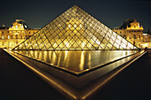 The Pyramid of the Le Grand Louvre Art Gallery and Cour Napolean by night in Paris, Ile de France, France.