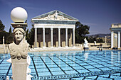 The Neptune Pool flanked by colonnades and the facade of a Greek temple in the grounds of Hearst Castle, San Simeon, California, United States of America.