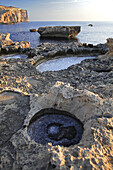 Sunset at Dwerja looking towards Crocadile Rock, on the island of Gozo, Malta