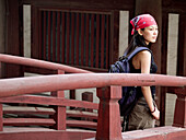 Young asian (Chinese) female walking on a bridge of an ancient temple in Zhengding. Hebei, China