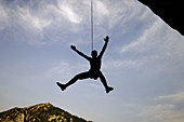 Climber hanging from rope. Bentué de Rasal. Huesca province, Aragón. Spain