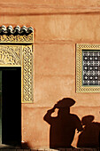 The shadows of human figures on the wall of a local house, Marrakech, Morocco