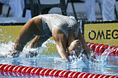 Action, Adult, Adults, Athlete, Athletes, Backstroke, Bathe, Bathes, Bathing, Bathing cap, Bathing caps, Breath, Breathing, Close up, Close-up, Closeup, Color, Colour, Compete, Competing, Competition, Competitions, Contemporary, Dive, Diving, Effort, Effo