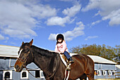 Three year old girl riding a horse, Stanhope Stables, Huntington, NY.