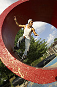 Skater skateboarding in red tube at a skate park in Kansas City, Missouri, USA