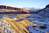 Snow blankets the Cache Valley and distant La Sal Mountains shortly before sunset, Arches National Park, Utah, USA.