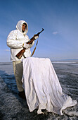 Seal hunter in winter on frozen Baikal lake, Siberia, Russia
