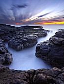 A cauldron on the Oregon, coast at sunset.