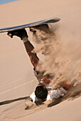 Backside slide spewing sand at Dumont Dunes. California. USA.