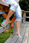 two teenage girls sitting on railing together at the cottage