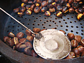 Chestnuts roasting in a street stall. Barcelona. Catalonia. Spain.