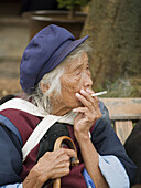 Old Naxi woman smoking, Lijiang, China