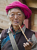 Nu woman smoking her corncob pipe, Nujiang Valley, China