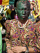 Man in green face and colorful dress, all part of the wacky Ati Atihan Festival, Kalibo, Philippines