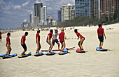 Students learning to ride a board on the Gold Coast. The region has produced many world-class surfers. 2005. Gold Coast. Queensland. Australia.