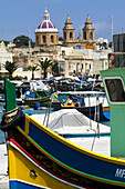 Local fishing boats or Luzzu, decorated with Osiris eyes for good luck. Marsaxlokk. Malta.