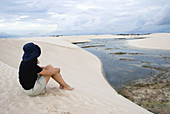 Brazil, Maranhao, sitting woman in the Lençois Maranhenses National Park.